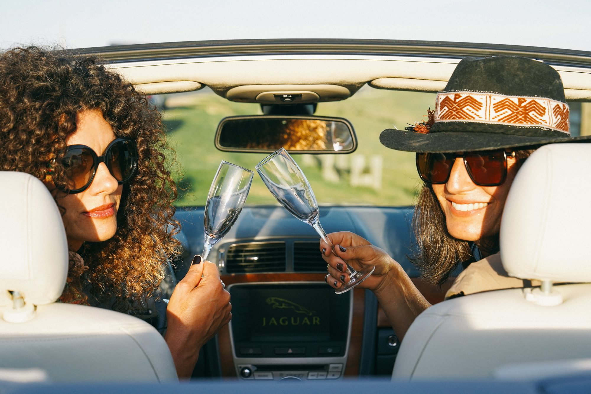 Guests toasting in a convertible